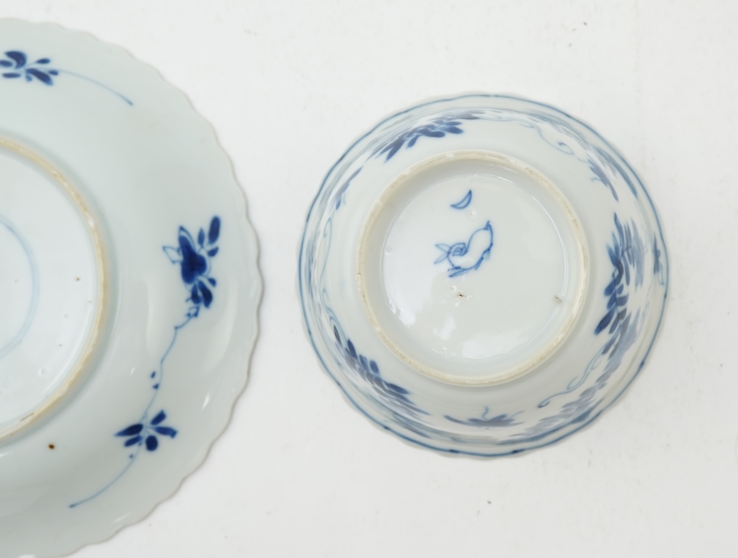 A Chinese blue and white tea bowl and saucer, Kangxi period